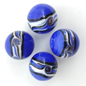 May include: Four blue glass marbles with swirling patterns of white, black, and maroon. The marbles are arranged in a circular pattern against a white background. Each marble has a glossy finish.