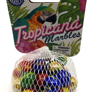 May include: A bag of colorful glass marbles. The packaging features a parrot illustration and the words "Tropicana Marbles". The marbles are red, yellow, blue, and green. The packaging also includes a warning about choking hazards.