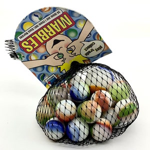 May include: A mesh bag filled with 24 colorful glass marbles. The bag has a tag that says "MARBLES" with a cartoon character holding marbles. The tag also says "Play, trade, collect!" and "24 16mm and 12mm 100% glass marbles."
