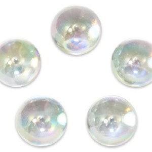 May include: Five iridescent glass marbles, each with a slightly different shade of white and a pearlescent finish.