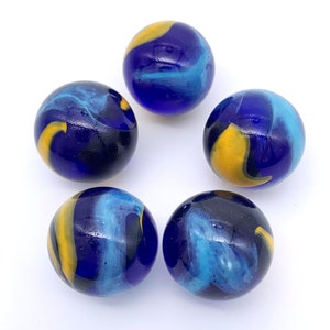 May include: Five blue glass marbles with yellow and light blue swirls.