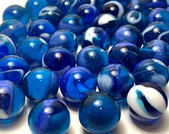 May include: A collection of blue glass marbles with white swirls. Some marbles are solid blue, while others have white streaks or swirls.