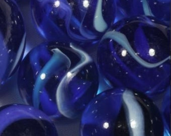 May include: A collection of blue glass marbles with white swirls. The marbles are arranged in a random pattern on a white surface.