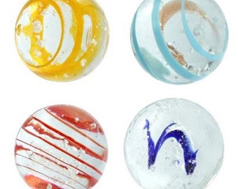 May include: Four glass marbles with different patterns. One marble has a yellow and white swirl pattern, one has a blue and white swirl pattern, one has a red and white stripe pattern, and one has a blue swirl pattern.