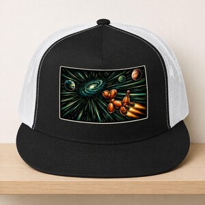 May include: A black and white trucker hat featuring a rectangular graphic on the front panel. The image depicts a brown balloon dog shaped like a rocket ship flying through deep space, past a glowing spiral galaxy and several colorful planets.