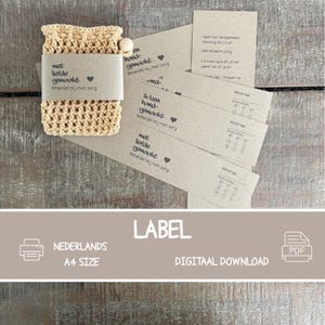 May include: A beige crocheted item with a wooden bead, and several gray labels with text in Dutch. The labels read "met liefde gemaakt" and "Behandel mij met zorg". The word "LABEL" is also visible.