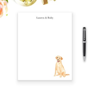 May include: A white notepad with the text "Lauren & Ruby" at the top. A watercolor illustration of a golden retriever dog is at the bottom of the notepad.