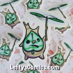 May include: A set of stickers featuring a cartoon character with a green leaf for a head and a brown body. The character is holding a stick with a leaf on top, which is spinning. The stickers are on a white background with pink flowers.