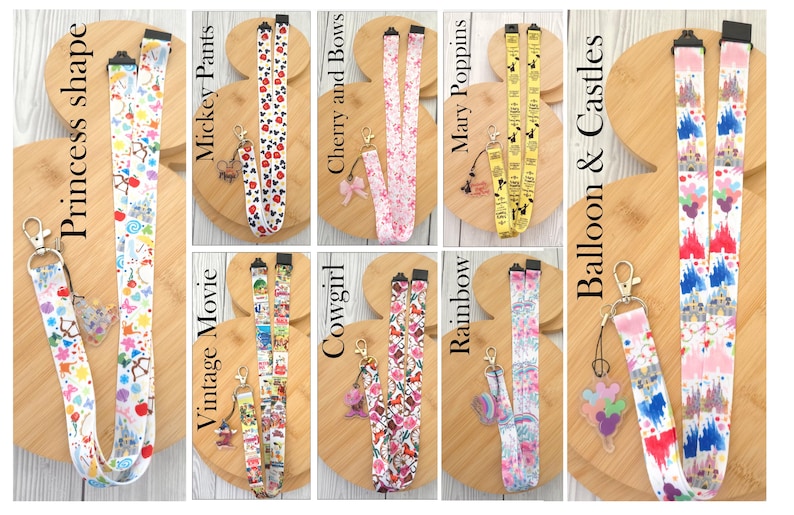May include: A collection of eight fabric lanyards featuring various colorful patterns including Princess shape, Mickey Pants, Cherry and Bows, Mary Poppins, Vintage Movie, Cowgirl, Rainbow, and Balloon & Castles, each with a metal clasp and charm.