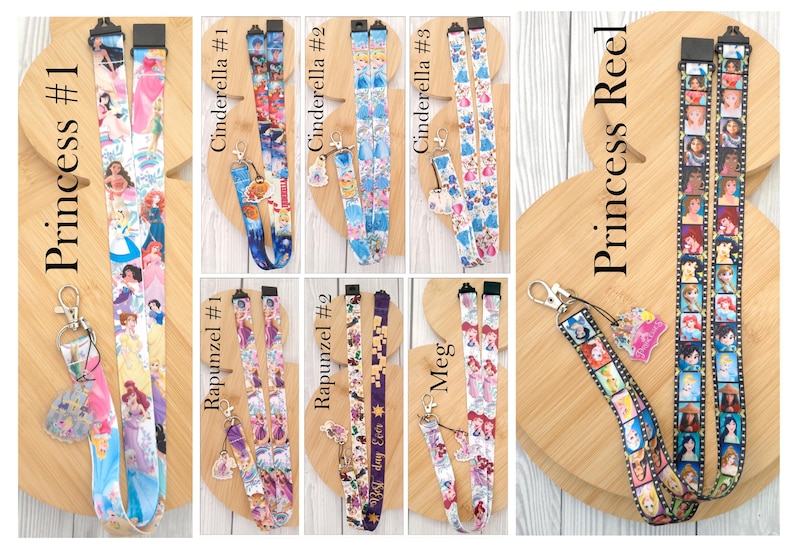 May include: A collection of fabric lanyards featuring various cartoon character prints and attached charms. The designs include Princess #1, Cinderella #1, #2, and #3, Rapunzel #1 and #2, Meg, and Princess Reel, each with distinct patterns and metal clips.