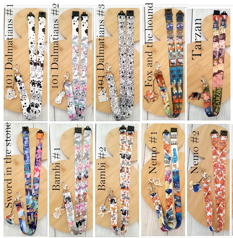 May include: A collection of ten fabric lanyards featuring various animated movie themes including 101 Dalmatians, Fox and the Hound, Tarzan, Sword in the Stone, Bambi, and Nemo, each equipped with a metal clasp and a matching character charm.