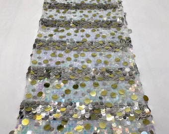 Puede incluir: Tela de malla blanca con lentejuelas doradas y plateadas en un patrón de rayas.