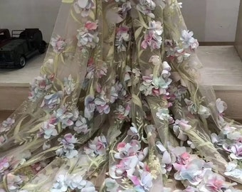 May include: A sheer fabric with a floral design featuring 3D flowers in shades of blue, pink, and green.