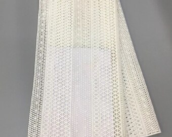 May include: White crochet fabric with a geometric pattern. The fabric has a delicate, openwork design with circles and triangles.