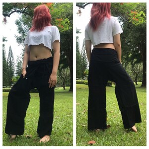 May include: Black wrap pants with a wide leg and a tie at the waist. The pants are made of a soft, comfortable fabric and are perfect for yoga, meditation, or lounging around the house.