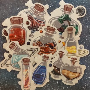 May include: A collection of stickers featuring various potion bottles with cork stoppers. The bottles contain colorful liquids and designs, including planets, trees, and swirling patterns. The stickers are on a starry background.