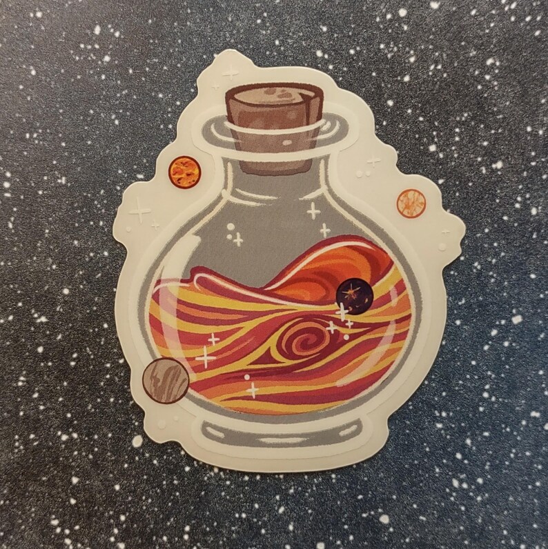 May include: A sticker featuring a glass bottle with a cork stopper, filled with swirling orange, red, and yellow liquid. Small planets and stars surround the bottle, creating a cosmic theme. The sticker has a white border.