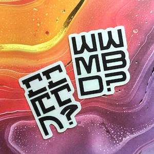 May include: Two white stickers with black text on a colourful background. One sticker reads "FF FC?" and the other reads "WW ME D?". The background has a mix of orange, purple, and gold colours.