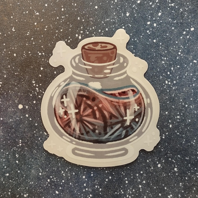 May include: A sticker featuring a potion bottle with a cork stopper. The bottle contains a swirling, reddish-brown liquid with blue and white accents. White cross-shaped designs are scattered around the bottle, and the sticker has a white border.
