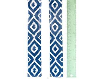 May include: Two rectangular fabric covers featuring a blue and white geometric diamond pattern. A green ruler is positioned next to the items, showing a length of approximately 12 inches. The text Nazca Indian Blue is printed below.