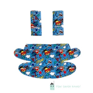 May include: A set of three blue fabric car seat belt covers with a comic book print featuring red, yellow, and white text that says "POW", "BANG", and "SMASH".
