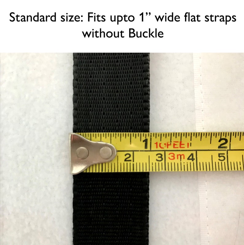 May include: A close-up of a black strap measured with a yellow tape measure. The tape measure reads 1 inch.  Standard size: Fits upto 1" wide flat straps without Buckle.