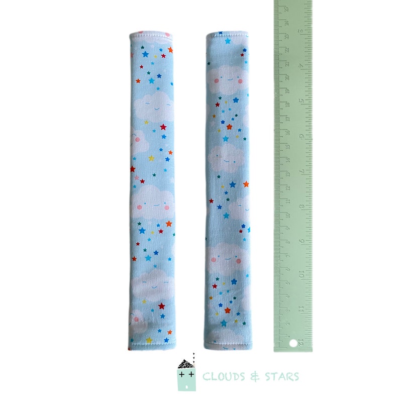 May include: Two blue fabric sleeves with a white cloud and colorful star pattern. The sleeves are approximately 11 inches long and are measured against a ruler. The text "CLOUDS & STARS" is printed below the ruler.