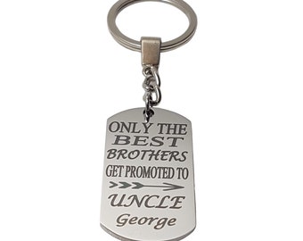 May include: Silver keychain with a silver tag that reads "Only the best brothers get promoted to Uncle George" with an arrow pointing to the right.