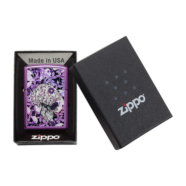 Zippo lighter with hidden skull floral artwork in an open Zippo box.