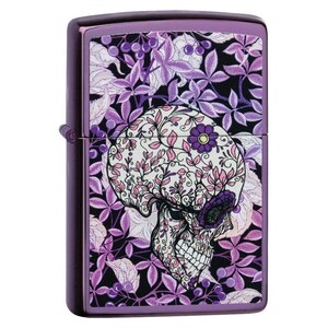 May include: Purple metal lighter with a floral skull design. The skull is decorated with pink and white floral patterns, set against a backdrop of purple leaves and berries. The lighter has a shiny, metallic finish.