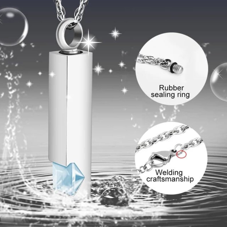 May include: Silver pendant necklace with a clear crystal and a silver chain. The pendant is a cylinder with a screw-on top and a rubber sealing ring. The chain has a welded clasp.