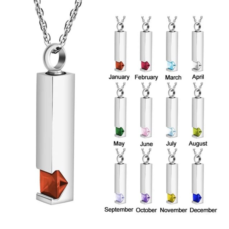 May include: Silver necklace with a rectangular pendant that has a small, colored gemstone at the bottom. The pendant is engraved with the months of the year, January through December, and each month has a corresponding gemstone color.