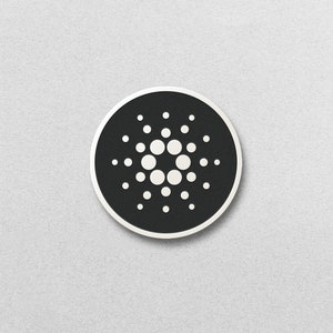 Puede incluir: Un logotipo circular en blanco y negro con un círculo blanco en el centro rodeado de círculos concéntricos de puntos blancos.