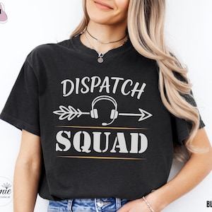 May include: Black t-shirt with the words "Dispatch Squad" in white, featuring a headset graphic and an arrow design. The shirt is a Comfort Colors brand.