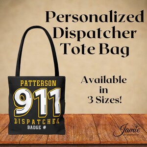 May include: Black tote bag with a yellow and white 911 graphic and the text "Patterson Dispatcher Badge #".