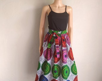 WAX skirt with disc rosettes pleated at the maxi or short belt length options