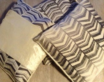 Trio of cameo ivory cushion covers and grey satin