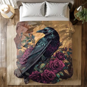 May include: A black raven perched on a bed of dark pink roses with green leaves. The raven has a dark blue sheen and a long, pointed beak. The background is a faded gold color with a watercolor effect.