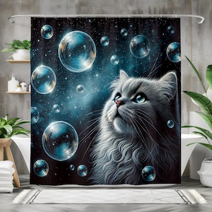 May include: A shower curtain featuring a fluffy gray cat gazing upwards at large, luminous bubbles floating in a starry, dark blue space. The cat has bright blue eyes and a pink nose, with a detailed, artistic style.