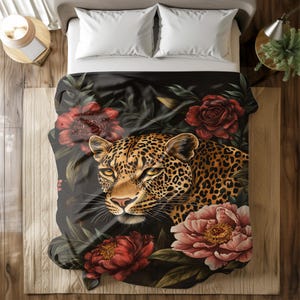 May include: A black duvet cover with a leopard print and floral design. The leopard is looking directly at the viewer with a fierce expression. The flowers are red, pink, and green.