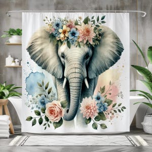 May include: A watercolor illustration of an elephant with a floral crown. The elephant is gray and has a long trunk. The flowers are pink, blue, and white. The background is a soft watercolor wash of blue and pink.