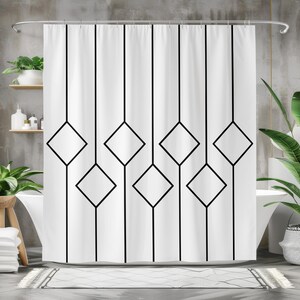 May include: White shower curtain featuring a geometric black diamond pattern. The curtain hangs from a silver rail and covers a white bathtub. The design features vertical black lines with diamond shapes.