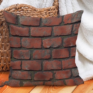 May include: A decorative throw pillow with a brick pattern. The pillow is made of a soft, textured fabric and features a realistic brick design in shades of red, brown, and gray.