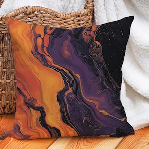 May include: A decorative throw pillow with an abstract design featuring swirling orange, purple, and black colors. The pillow has a soft, textured fabric and is perfect for adding a touch of modern style to any room.