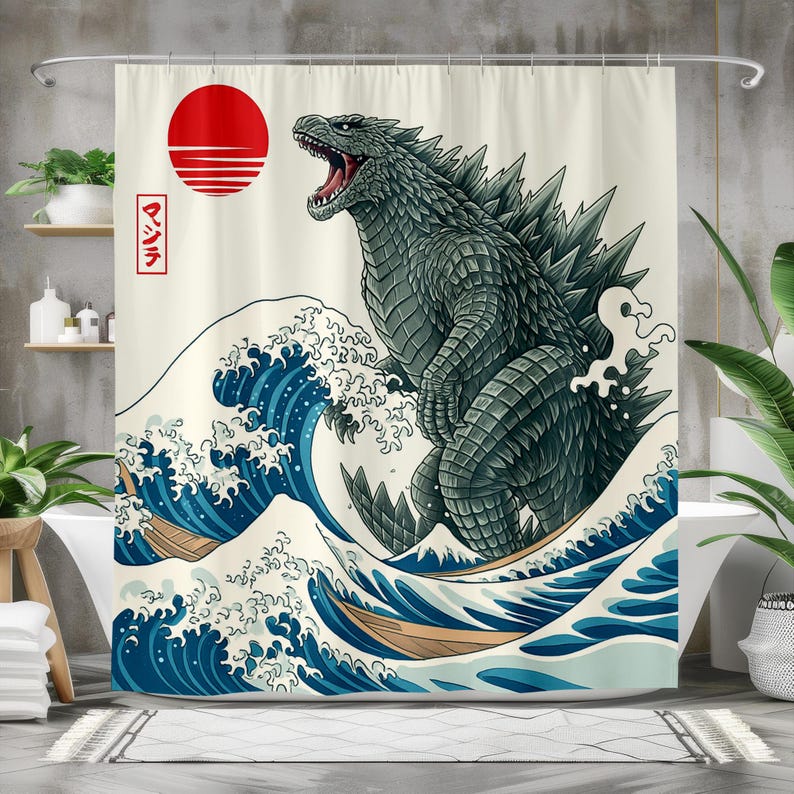 May include: A shower curtain featuring a stylized illustration of Godzilla emerging from a large ocean wave. The design includes a red sun and Japanese text. The color palette includes shades of blue, green, and white.
