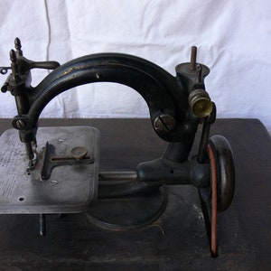 Used 1863 Wilcox and Gibbs Treadle Sewing Machine With Base Not Fully Tested