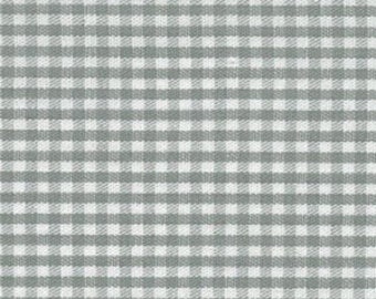May include: White and gray gingham fabric with a subtle texture. The fabric has a small, even check pattern.