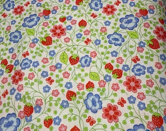 May include: White fabric with a repeating pattern of red strawberries, blue and red flowers, green leaves, and small butterflies. The design is a mix of floral and fruit elements.