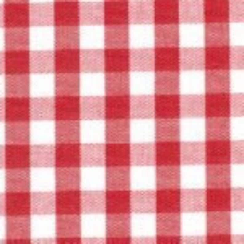 May include: Red and white checkered fabric with a square pattern.