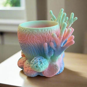 May include: A set of three ceramic mugs with a speckled, matte finish. The mugs are in shades of cream, light gray, and dark gray. Each mug has a simple, minimalist design, perfect for coffee or tea.